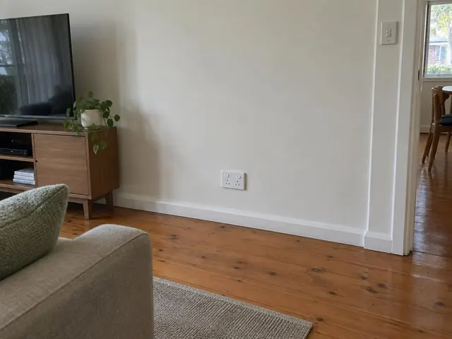 White power point on a painted living room wall above timber floorboards in Killarney Vale